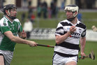 Sarsfields, Eamon Cleary,<br />
and<br />
Turloughmore's, Gary Burke,<br />
during the Senior Hurling Championship at Athenry.