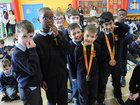 <br />
Pupils with the gold medals of the Para Olympics won by Eoghan Clifford of  NUIGalway  during his visit to rhe school. 