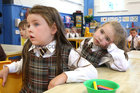 Annarose and Robyn listen to their teacher speaking during their first day at school in Junior Infants at Scoil Fhursa this week.