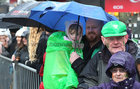 Keeping covered during the heavy rainfall at the St Patricks Day Parade in the city centre.