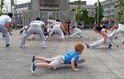 A young skateboarder passes by as Grupo Candeias perform their acrobatics and energetic music at Eyre Square as part of the Capoeira Festival at the weekend. Capoeira is a blend of martial art, acrobatics, music, and dance that originated in Brazil. The event was hosted by the local Grupo Candeias who train twice a week with Contra Mestre Mola at Creaven House in the Claddagh.