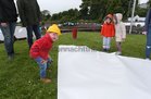 A young builder helps with the construction of the paper boat at Kinvara.