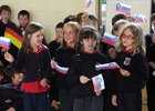 Pupils wave flags of the partner countries during their concert at Scoil Shéamais Naofa.<br />
<br />
Scoil Shéamais Naofa, Bearna, hosted a visit of staff from their partner schools in France, Germany, Hungary and Slovenia. The pupils at the school presented a concert of Irish and international dance music and song. 