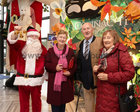 Santa (Fred Diviney) with Eileen O'Donovan, Con O'Donovan and Ann King at the Mervue and Renmore Community Christmas lunch in the Connacht Hotel.