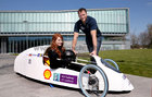 Connacht Rugby's Eoin McKeon gives a helping hand to fourth year mechanical engineering student, driver Maryrose McLoone, after he unveiled a super fuel-efficient car at NUI Galway. Eoin is an engineering graduate of NUI Galway. The Geec (Galway nenergy-efficient car) designed and road tested by NUI Galway engineering students, will represent Ireland next month in the prototype electric category at Shell Eco-marathon Europe in Rotterdam. Success is measured on who can drive the furthest on the equivalent of 1 kilowatt-hour of electricity or 1 liter of fuel. Designed from scratch the car is efficient enough to drive from Galway to Dublin on less than €1 worth of electricity, the equivalent of 1,700 miles per gallon of fuel.<br />
