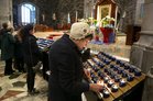 Members of the congregation light candles at the end of a lunchtime session of the Annual Solemn Novena at Galway Cathedral this week.