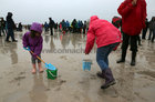 Children at play on the tidal strand as the rain comes down during the Omey Races last Sunday.