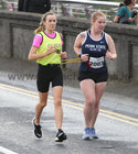 Devin Adams, right, taking part in the Galway Clinic Streets of Galway 8k Road Race as it passes over Wolfe Tone Bridge last Saturday.