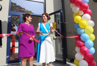 Hildegarde Naughton, Minister of State at the Department of Transport, cuts a tape to officially open the new extension to Scoil Fhursa at Nile Lodge. Also in the photograph is Bríd Ní Neachtain, Príomhoide