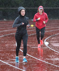 Participants in the GOAL Mile during the heavy rainfall at the NUI Galway Dangan running track on Christmas Day. 