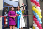 Hildegarde Naughton, Minister of State at the Department of Transport, prepares to cut a tape to officially open the new extension to Scoil Fhursa at Nile Lodge. Also in the photograph is Bríd Ní Neachtain, Príomhoide