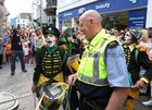 A member of Trans Express switches caps with Community Garda Kevin Farrelly as the performers meander through Galway city centre with their street show Mobile Homme as part of Galway International Arts Festival.