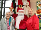 Pictured with Santa (Fred Diviney) at the Mervue and Renmore Community Christmas lunch in the Connacht Hotel are Angela Fahy, Mervue and Anne Abberton Egan, organiser.