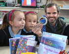 Round-the-world in seven days challenge champion Gary Thornton was back teaching at the Claddagh National School last Friday after he ran seven marathons, on seven continents over seven days and won all seven races. Gary is pictured showing one of his medals to pupils Rachel Vignoles and Olivia Klinko in his senior infants class.  