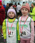 Sisters Aisling and Olivia Gorman from Craughwell wear their medals after taking part in the childrens event at the 2023 Fields of Athenry 10k Road Race on St Stephen's Day.