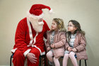 Santa Claus chatting with sisters Lacey Lee and Shianne Sweeney from Ballybane at the Ballybane Christmas Fair in the local Community Centre last Saturday. Lacey Lee was celebrating her 4th birthday with Shianne (6) at the fair when they met Santa.