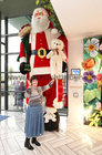 Áine Garvey beside a giant size Santa Claus at the entrance to the Connacht Hotel during the Mervue and Renmore Community Christmas lunch in the Connacht Hotel.