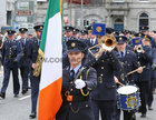 Garda Claire Burke carries the Irish flag in front of the Garda Band at Eyre Square at the re-enactment of the arrival of the first Gardaí to Galway on 25th September 1922, during the commemoration by Gardaí in Galway of the 100-year anniversary of the foundation of An Garda Síochána last Sunday.