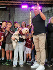 Galway Manager Pádraic Joyce beside his daughter Jodie holding her pet dog during the homecoming ceremony at Pearse Stadium on Monday evening.