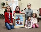 Emily Brosnan, Hannah and Francis Carr, and Car√≠osa and Sarah Williams, all from Bearna, at the Cillin at Bearna Church for the launch of 'The Journey', prints of the late Chris Montague's painting in aid of children with Down's Syndrome in Galway.