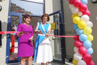 Bríd Ní Neachtain, Príomhoide, looks on as Hildegarde Naughton, Minister of State at the Department of Transport, cuts a tape to officially open the new extension to Scoil Fhursa at Nile Lodge. 