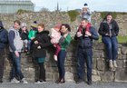 Spectators look on as the East Galway Tractor Run leaves Athenry Mart last Sunday. The event was held in aid of Hand in Hand, the Children's Cancer Charity. Hand in Hand is a non-profit organisation which provides the families of children with cancer with much-needed practical support.