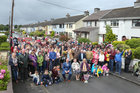 Eileen Molloy with her son Tommy and daughter Maureen Geary surrounded by family members, neighbours and friends at the surprise street party to to mark her 100th birthday at Davis Road in Shantalla.