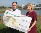 Michael Uniacke from Gort presenting a cheque for €1600.98 to Mary Tierney of Galway Hospice before the start of the Galway Memorial Walk in aid of Galway Hospice last Sunday. The money was raised by Michael's Memorial Walk in memory of his brother Peter Uniacke.
