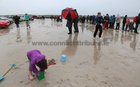 Children at play on the tidal strand as the rain comes down during the Omey Races last Sunday.