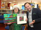 Martina O’Connor, holding some of her work, and Neil Molloy of Galway Bay FM at the opening of the RehabCare Art Exhibition in Ballybane Library. Neil officially opened the exhibition.