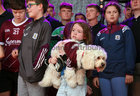 Galway Manager Pádraic Joyce's daughter Jodie holding her pet dog during the homecoming ceremony at Pearse Stadium on Monday evening.