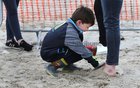 Luke Bergin making sand shoes for his mother Caroline Mills at the Omey Races last Sunday.