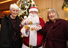 Peggy Kelly and Rita Larkin pictured with Santa at the Mervue and Renmore Community Christmas lunch in the Connacht Hotel.