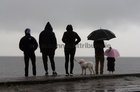 The weather turns dull and the rain comes down at Blackrock during the COPE Galway Christmas Day Swim.