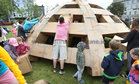 Building the dome.<br />
A replica of the dome of Galway Cathedral built with cardboard boxes on Saturday was Olivier Grossetête’s 'The People Build' architectural project at Eyre Square as part of Galway International Arts Festival. The following day the heavy rainfall and wind did not deter children, and some adults, demolishing the dome. The wet weather caused the dome to partially collapse. Following it's demolition the cardboard was taken away by Walsh Waste for recycling.