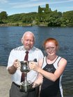 Paddy Cronin of Galway Rowing Club presenting Anna Pim of Lagan Scullers with her trophy after she won the Junior 14 Singles event at the Galway Regatta.