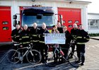 <br />
Fire Fighter Kiwean Considine, presents a cheque to Deirdre Tomkins and Niamh Killilea, UHG the proceeds of a cycle from Galway to Cork in aid of the late Fire Fighter Niall Tomkins, Memorial Fund , to fund the family room projecy for Cancer Services at UHG/ Also in the picture are Fire Fighters Kevin Treacy, Tomas O Rourke, Colin Downes, Sup Officer Paul Morris, Keith Badger  and Paddy Clarke, Station Officer. 