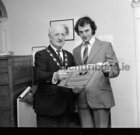 Inis O.rr man Thomas A Joyce (22) being presented by Mayor of Galway, Ald Fintan Coogan TD, with a certificate for Deed of Bravery awarded by Comhairle na Mire Gaille in November 1974. While working as one of three lightkeepers unloading goods at Inistearaght Lighthouse, he risked his life to save keeper-in-charge C.J. Harrington from certain death. According to the citation, Mr Harrington fell head over heels down the cliff rail incline when Mr Joyce stepped out, grabbed him and slowed the fall. .Had it not been for Mr. Joyce.s action, there is no doubt that Mr. Harrington would have continued to fall down the smooth concrete incline railway and been killed on striking the concrete wall at the bottom of the rock,. it added.