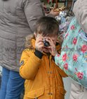Snap . . . looking at slides in a small camera viewer at the religious goods stall outside Galway Cathedral during the the annual Solemn Novena this week.