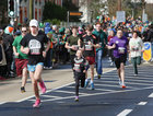 Some of athletes who took part in a run on St Patrick’s run down University Road before the start of the parade.