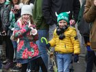 Young spectators dressed for the weather during the St Patrick's Day Parade in the city