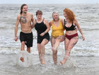 Fionn Moloughney and his sister Ciara and Hannah Kiely, Clarenbridge, and her daughter Medb Kiely-Cuddy, after taking their dip at Blackrock during the COPE Galway Christmas Day Swim.