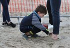 Luke Bergin making sand shoes for his mother Caroline Mills at the Omey Races last Sunday.
