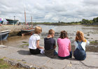 Young spectators waiting for the tide to rise for the traditional boat and cimín (seaweed) races at the Cruinniu na Mbad Festival at Kinvara Pier. 